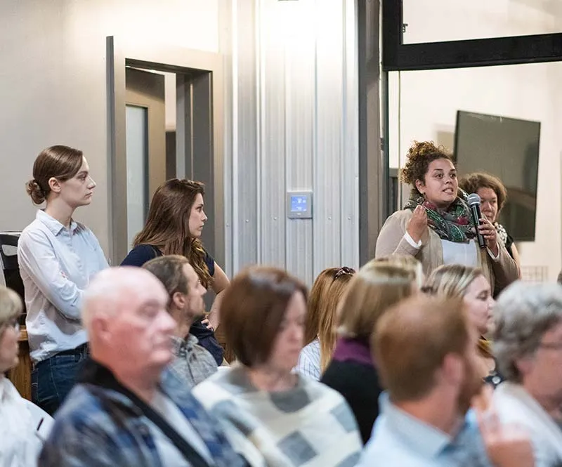 Women with microphone ask question during presentation